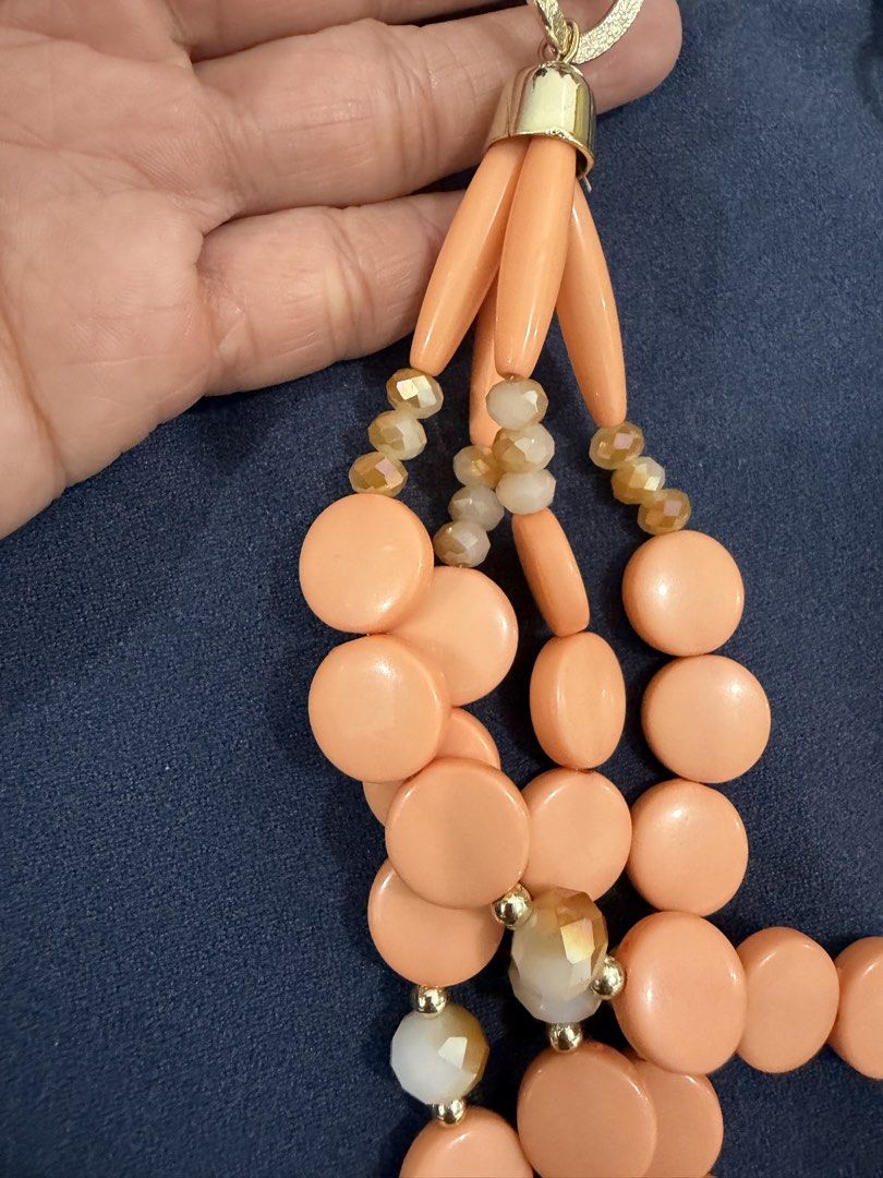 Multi-strand peach statement necklace with gold chain (Category: Necklaces) located in Makati City. Submitted by petite_preloved2 (Listing ID 1469056532, Image 2). Description: - Style: Multi-strand statement necklace in gorgeous peach tones - Details: Features round beads, cylindrical beads, sparkly faceted crystals, and gold-tone spacers - Design: Upper section features a trendy chunky gold chain link with a secure closure.