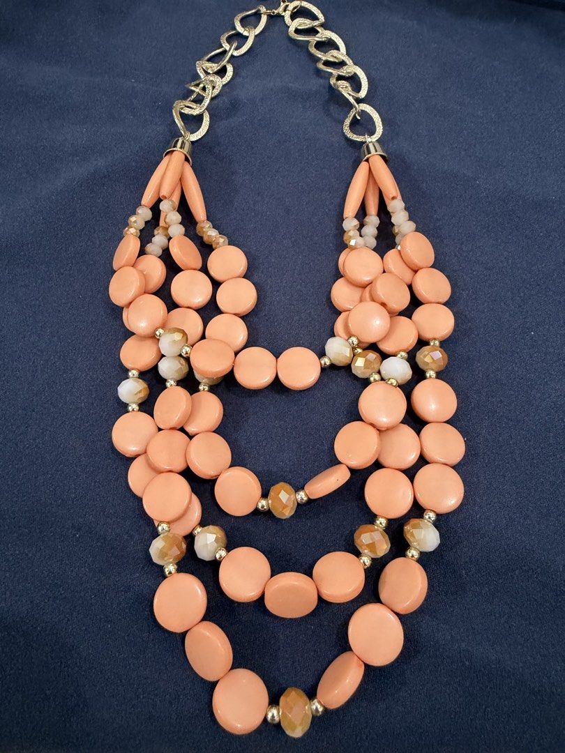 Multi-strand peach statement necklace with gold chain (Category: Necklaces) located in Makati City. Submitted by petite_preloved2 (Listing ID 1469056532, Image 1). Description: - Style: Multi-strand statement necklace in gorgeous peach tones - Details: Features round beads, cylindrical beads, sparkly faceted crystals, and gold-tone spacers - Design: Upper section features a trendy chunky gold chain link with a secure closure.