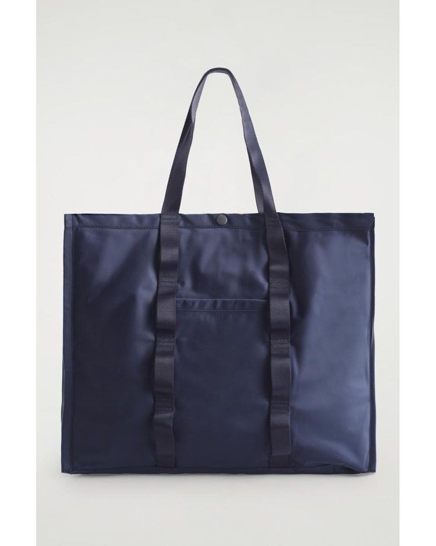 Navy Blue Nylon Tote Bag with Webbed Straps (Category: Luxury Bags & Wallets) located in Manila. Submitted by pikkathchu (Listing ID 1469014407, Image 1). Description: - Color: Navy blue - Material: Lightweight and durable nylon - Design: Very spacious with clean lines - Handles: Sturdy webbed carry handles and adjustable shoulder straps - Pockets: Convenient small front pocket for quick access items - Closure: Top snap button closure - Condition