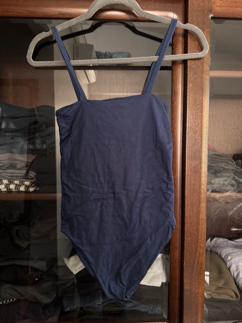 Navy Blue Sleeveless Bodysuit (Category: Sleeveless) located in Quezon City. Submitted by ianne.declutter (Listing ID 1469002887, Image 3). Description: used max 2 times - Color: Navy blue - Design: Square neckline with thin double straps - Material: Soft and stretchy fabric - Features: Convenient bottom snaps, great for layering or on its own - Condition: Excellent, clean with no stains or damage.