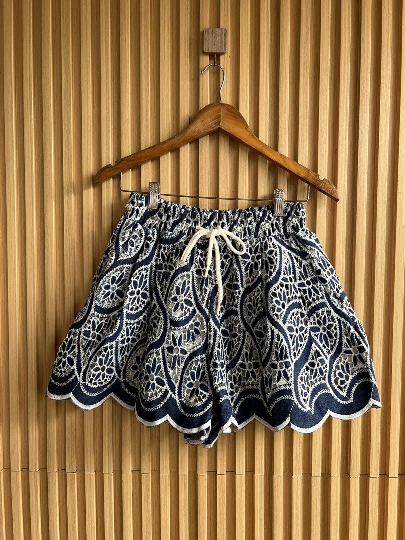 Navy Blue White Lace Embroidered Drawstring Shorts (Category: Shorts) located in Lipa City. Submitted by thyra06 (Listing ID 1468977235, Image 2). Description: - Color: Navy blue with intricate white lace embroidery - Design: Scalloped hem and flared, lightweight silhouette - Fit: Elastic waistband with a thick white adjustable drawstring - Condition: Excellent, clean fabric with no stains or fraying - Style: Ideal for warm weather and casual wee