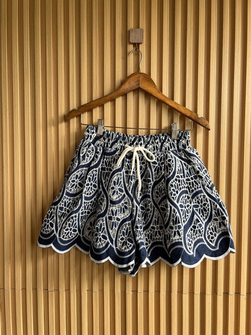 Navy Blue White Lace Embroidered Drawstring Shorts (Category: Shorts) located in Lipa City. Submitted by thyra06 (Listing ID 1468977235, Image 1). Description: - Color: Navy blue with intricate white lace embroidery - Design: Scalloped hem and flared, lightweight silhouette - Fit: Elastic waistband with a thick white adjustable drawstring - Condition: Excellent, clean fabric with no stains or fraying - Style: Ideal for warm weather and casual wee