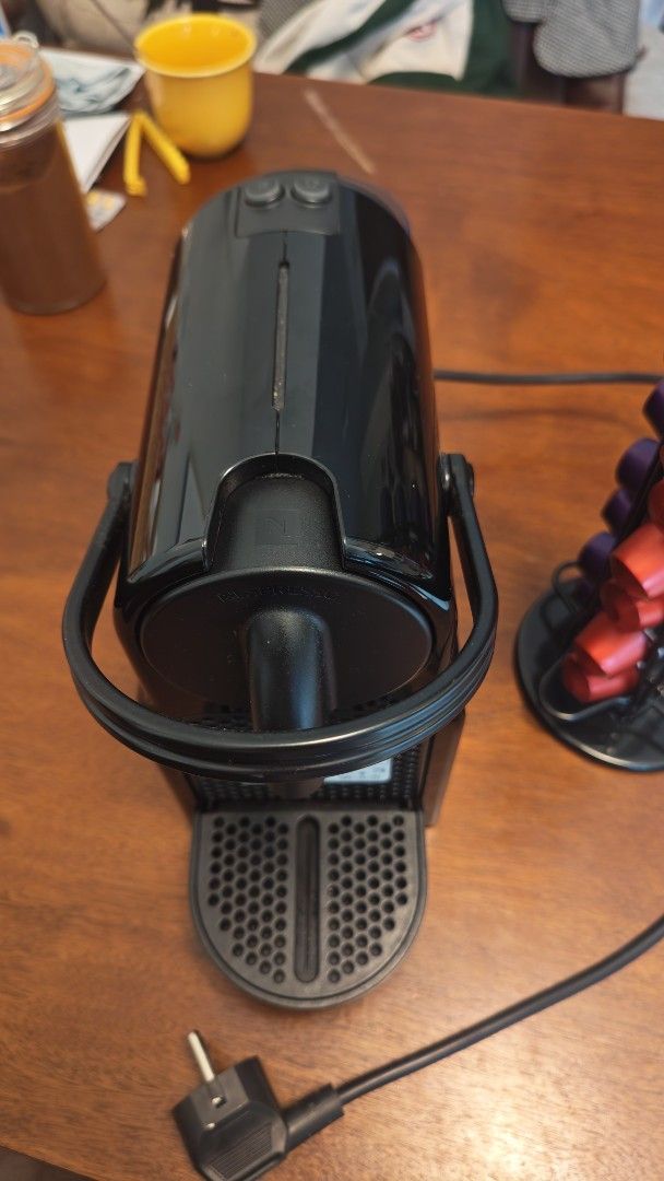 Nespresso Machine with Capsule Holder (Category: Coffee Machines & Makers) located in Mandaluyong City. Submitted by baggaholic_ (Listing ID 1469015064, Image 2). Description: - Color: Sleek black, compact design ideal for small kitchens - Features: Removable water tank at the back, standard plug - Bonus: Includes a revolving wire coffee pod tower stocked with capsules ‼️ - Condition: Works great, makes quick morning espressos Reason for selling: