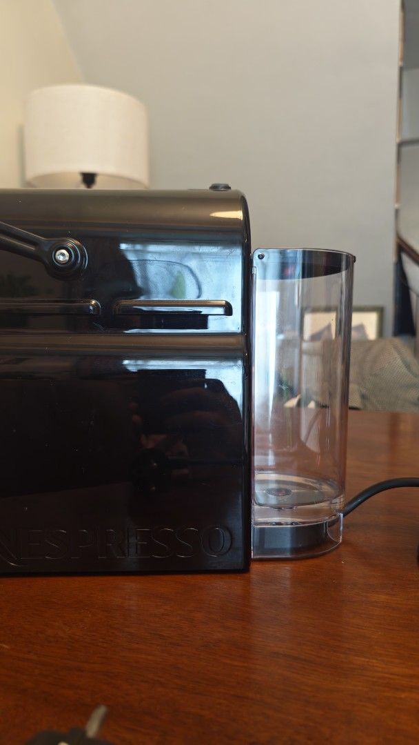 Nespresso Machine with Capsule Holder (Category: Coffee Machines & Makers) located in Mandaluyong City. Submitted by baggaholic_ (Listing ID 1469015064, Image 3). Description: - Color: Sleek black, compact design ideal for small kitchens - Features: Removable water tank at the back, standard plug - Bonus: Includes a revolving wire coffee pod tower stocked with capsules ‼️ - Condition: Works great, makes quick morning espressos Reason for selling: