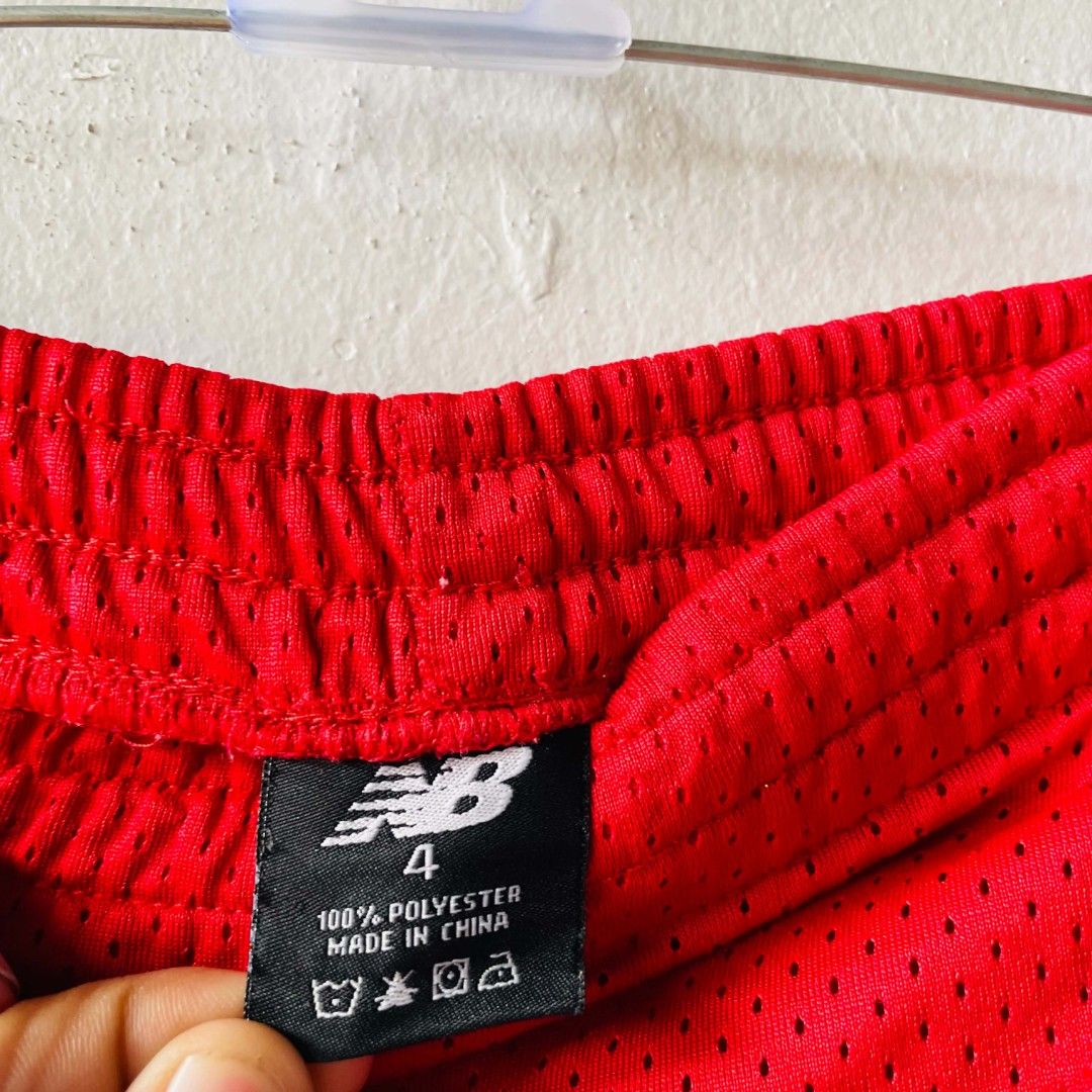 New Balance Red Mesh Shorts (Category: Babies & Kids Fashion) located in San Mateo. Submitted by safeearth21 (Listing ID 1468951060, Image 3). Description: - Brand: New Balance - Color: Bright red with black side stripes - Size: 4 (fits ages 4-5 years old) - Material: 100% breathable polyester - Features: Easy pull-on elastic waistband - Condition: Great for active play, sports, and everyday wear.