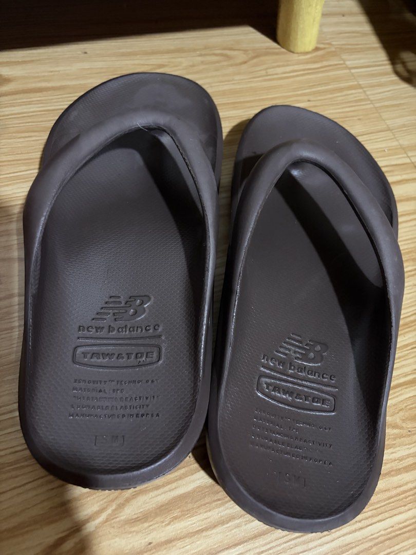 New Balance x TAW & TOE Zeroity Flip Flops Brown (Category: Slippers & Slides) located in Siquijor. Submitted by yhostuff (Listing ID 1469012079, Image 2). Description: - Collaboration: New Balance x Taw & Toe - Colorway: Deep brown - Size: M - Comfort Tech: Zeroity technology for ultimate comfort and reactivity - Design: Slip-on, super lightweight with thick cushioned soles and textured footbed for extra grip - Condition: Soles show light wave p