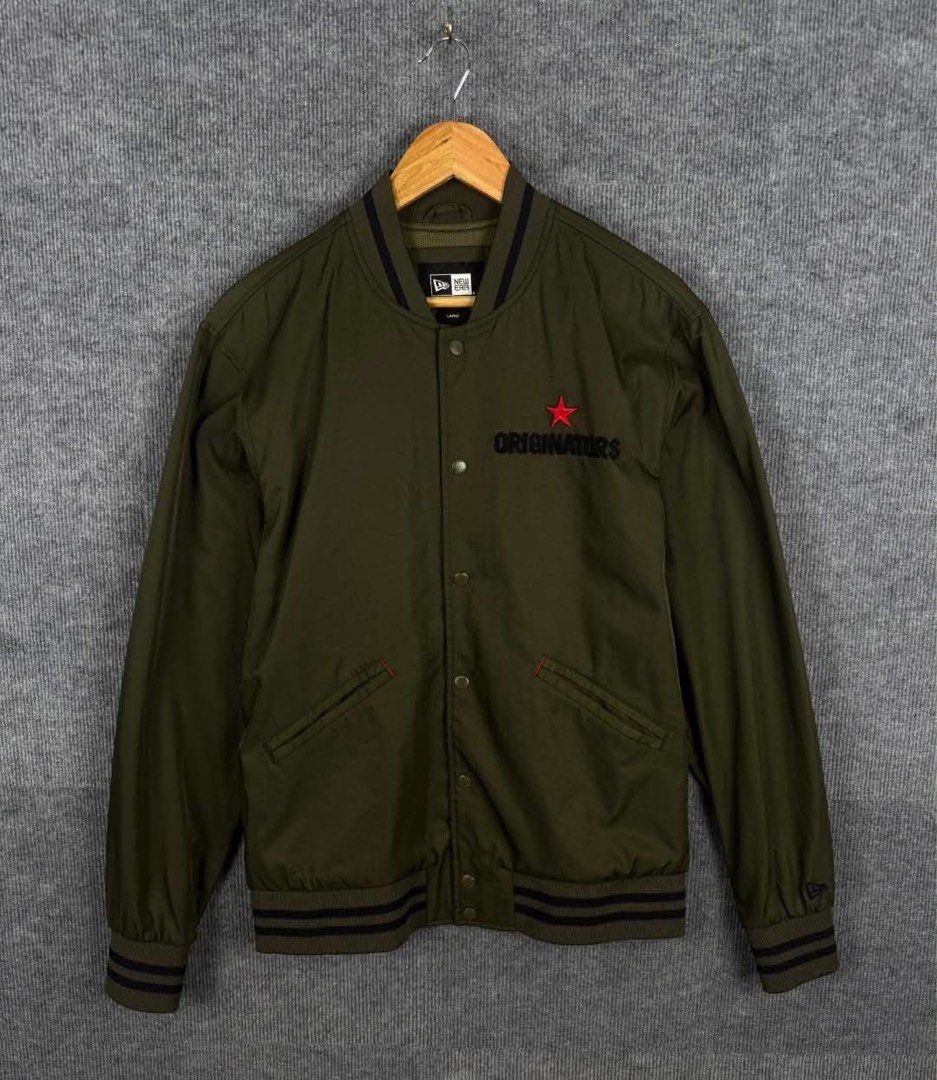New Era Originators Olive Green Varsity Jacket Size Large (Category: Coats, Jackets and Outerwear) located in Manila. Submitted by nicosagm11t (Listing ID 1468997260, Image 2). Description: - Brand: New Era - Color: Olive Green - Size: Large 22x28 - Style: Varsity jacket with snap-button front closure - Details: Striped ribbed collar, cuffs, and hem - Embroidery: 'ORIGINATORS' lettering with red star on front, large 'NEW ERA' lettering on back - 