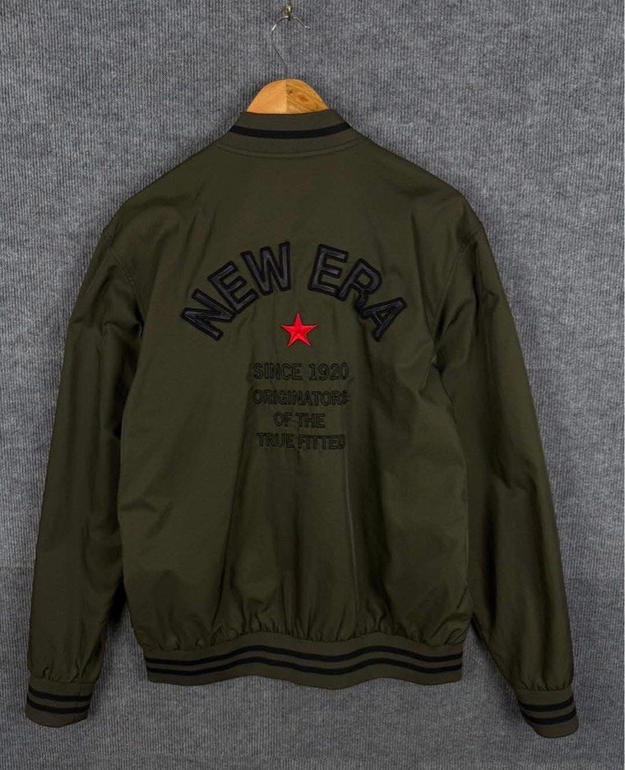 New Era Originators Olive Green Varsity Jacket Size Large (Category: Coats, Jackets and Outerwear) located in Manila. Submitted by nicosagm11t (Listing ID 1468997260, Image 1). Description: - Brand: New Era - Color: Olive Green - Size: Large 22x28 - Style: Varsity jacket with snap-button front closure - Details: Striped ribbed collar, cuffs, and hem - Embroidery: 'ORIGINATORS' lettering with red star on front, large 'NEW ERA' lettering on back - 