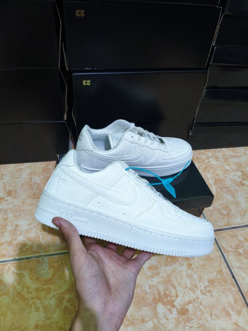 Nike Air Force 1 Low Snake Print (Category: Sneakers) located in Manila. Submitted by eugeneamb94806 (Listing ID 1469133008, Image 2). Description: Nike Air Force 1 sneakers with snake skin texture pattern all over. Black and white color options available. Classic low-top design with chunky midsole and standard lace-up closure. Teal zip tie tag attached to the laces. Solid rubber outsole for grip. Boxes stacked in the background..