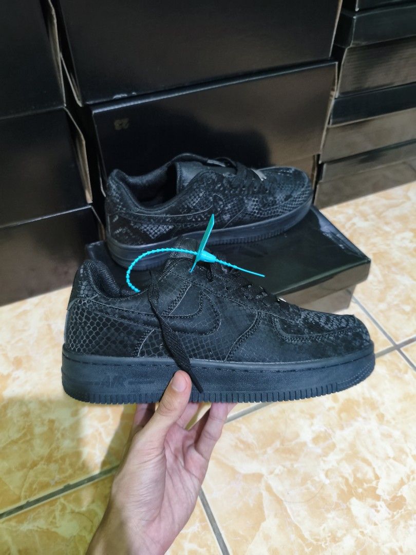 Nike Air Force 1 Low Snake Print (Category: Sneakers) located in Manila. Submitted by eugeneamb94806 (Listing ID 1469133008, Image 1). Description: Nike Air Force 1 sneakers with snake skin texture pattern all over. Black and white color options available. Classic low-top design with chunky midsole and standard lace-up closure. Teal zip tie tag attached to the laces. Solid rubber outsole for grip. Boxes stacked in the background..