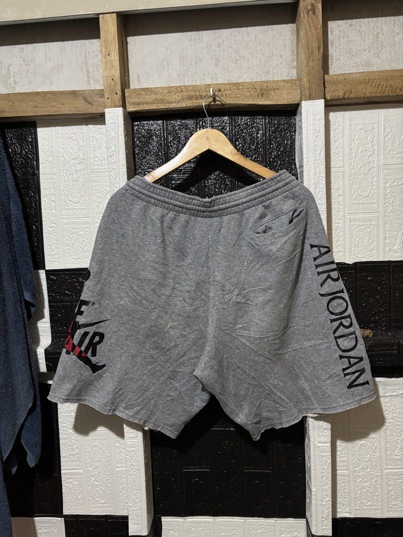 Nike Air Jordan Grey Sweatshorts (Category: Shorts) located in Lopez. Submitted by thrift.ni.roms22 (Listing ID 1468945773, Image 2). Description: - Brand/Style: Nike Air Jordan grey fleece sweatshorts - Design: Large Nike Air & Jumpman graphic on left leg, vertical Air Jordan text on back right - Fit & Comfort: Elastic waistband with black drawstring, casual everyday streetwear - Details: Raw cut hems and a convenient single back pocket.