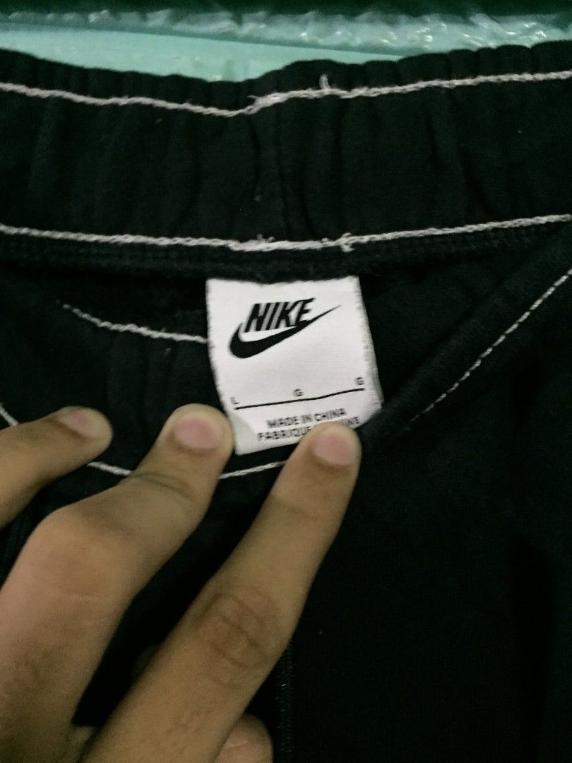 Nike Big Swoosh Black Sweatpants Size L (Category: Joggers) located in Imus. Submitted by thrifts_select (Listing ID 1469041002, Image 3). Description: - Authentic Nike sweatpants in classic black - Size: Large - Bold giant white swoosh logos on both legs - Elastic waistband with adjustable drawstrings for a secure fit - Stylish white contrast stitching along seams and cuffs - Made from ultra-comfortable, breathable cotton - Made in China.