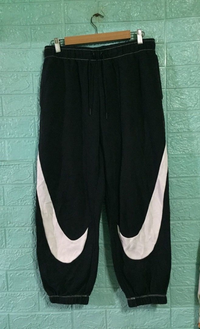 Nike Big Swoosh Black Sweatpants Size L (Category: Joggers) located in Imus. Submitted by thrifts_select (Listing ID 1469041002, Image 1). Description: - Authentic Nike sweatpants in classic black - Size: Large - Bold giant white swoosh logos on both legs - Elastic waistband with adjustable drawstrings for a secure fit - Stylish white contrast stitching along seams and cuffs - Made from ultra-comfortable, breathable cotton - Made in China.
