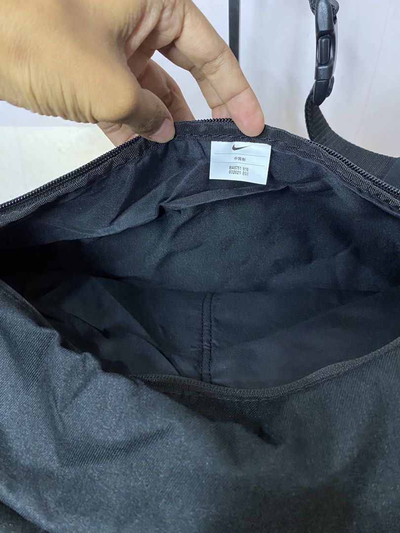 Nike Black Crossbody Bag (Category: Sling Bags) located in Manila. Submitted by onfleekapparelph (Listing ID 1469068134, Image 3). Description: - Authentic Black Nike Crossbody Bag - Style code: BA5751 010 - Large main compartment with secure zipper closure - Convenient internal mesh pocket for organization - Front zippered pocket featuring dual pull cords - Adjustable strap equipped with a sturdy plastic buckle - Bold Nike logo printed on the fr