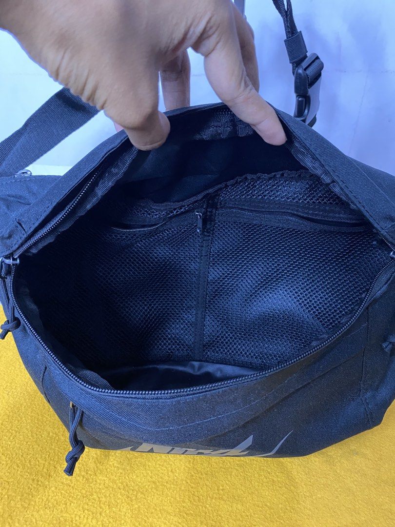 Nike Black Crossbody Bag (Category: Sling Bags) located in Manila. Submitted by onfleekapparelph (Listing ID 1469068134, Image 2). Description: - Authentic Black Nike Crossbody Bag - Style code: BA5751 010 - Large main compartment with secure zipper closure - Convenient internal mesh pocket for organization - Front zippered pocket featuring dual pull cords - Adjustable strap equipped with a sturdy plastic buckle - Bold Nike logo printed on the fr