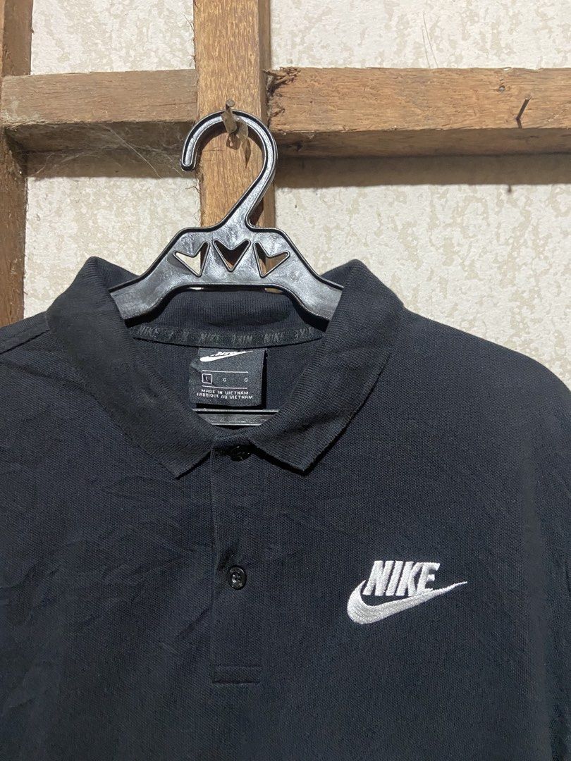 Nike Black Polo Shirt (Category: Tshirts & Polo Shirts ) located in Cagayan de Oro. Submitted by mindanao_thrifters (Listing ID 1468944620, Image 2). Description: - Brand: Nike - Item: Classic Polo Shirt - Color: Black with white embroidered chest logo - Size: Large (fits true to size) - Material: 100% Cotton (Made in Vietnam) - Condition: Good pre-loved/casual piece - Styling: Easy to match with jeans or shorts for everyday wear.