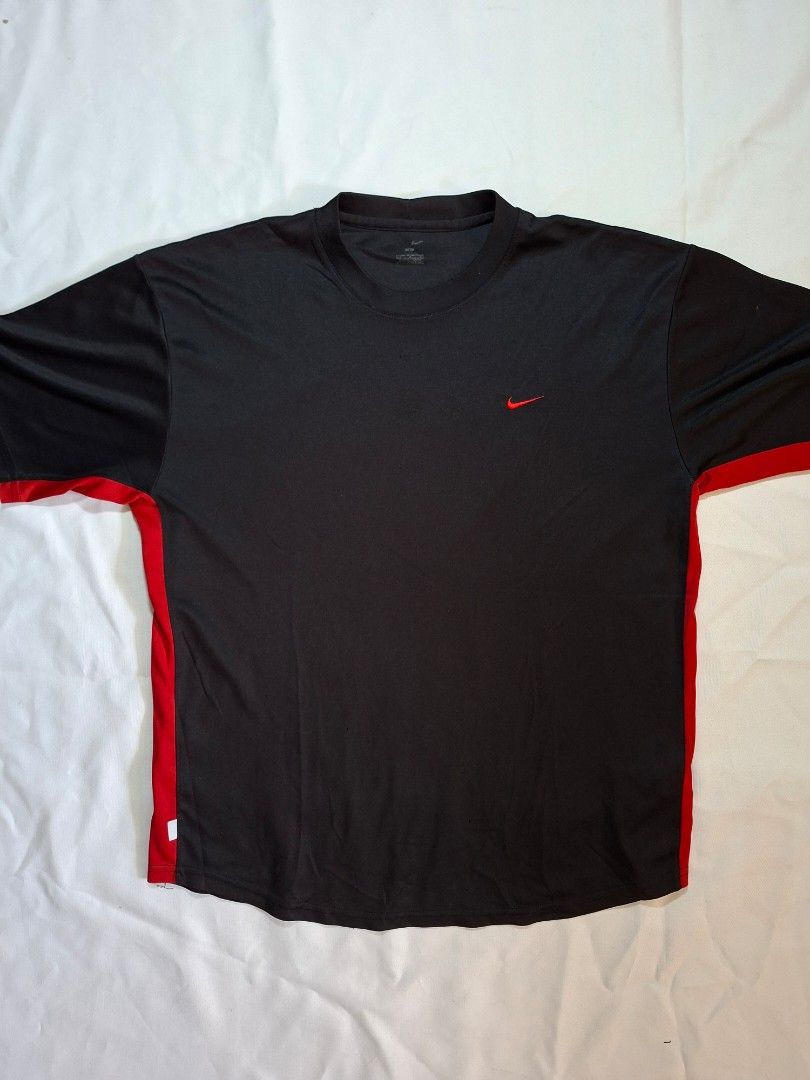Nike Black Red Athletic T-Shirt (Category: Tshirts & Polo Shirts ) located in Baguio. Submitted by restyrille77846 (Listing ID 1469094846, Image 1). Description: - Brand: Nike - Color: Black with red accents - Style: Athletic t-shirt with short sleeves and crew neck - Details: Embroidered red swoosh on chest and stylish red side piping - Size/Fit: Measures approximately 22 inches across the chest - Condition: Clean neckline print tag, well-mainta