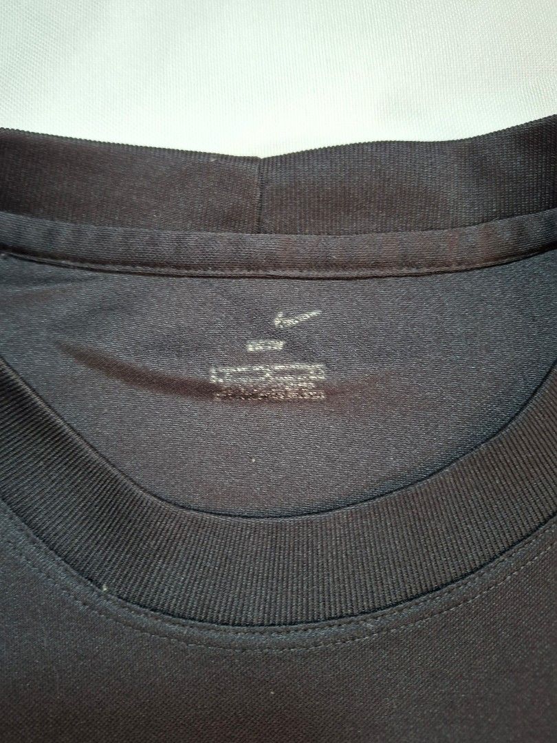 Nike Black Red Athletic T-Shirt (Category: Tshirts & Polo Shirts ) located in Baguio. Submitted by restyrille77846 (Listing ID 1469094846, Image 2). Description: - Brand: Nike - Color: Black with red accents - Style: Athletic t-shirt with short sleeves and crew neck - Details: Embroidered red swoosh on chest and stylish red side piping - Size/Fit: Measures approximately 22 inches across the chest - Condition: Clean neckline print tag, well-mainta
