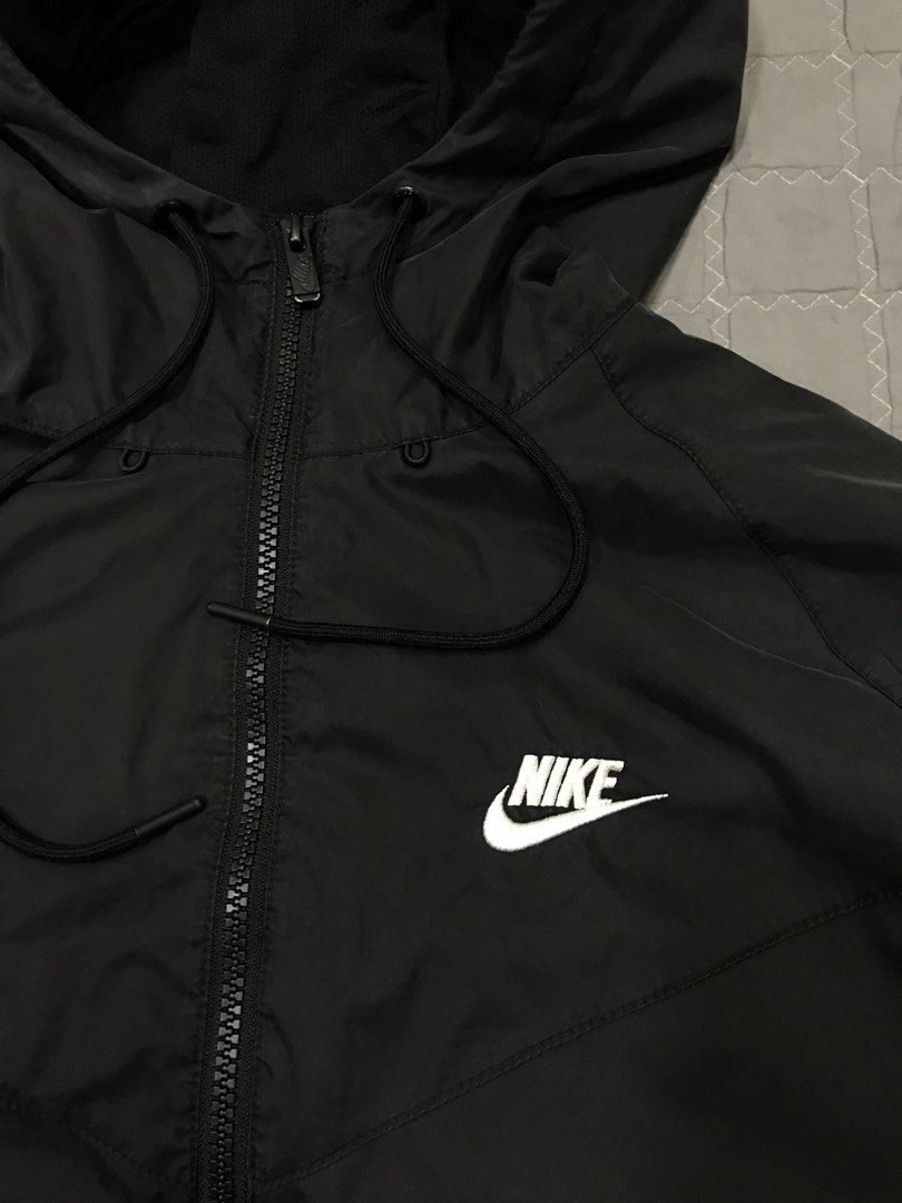Nike Black Windbreaker Jacket and Pants Set (Category: Coats, Jackets and Outerwear) located in Imus. Submitted by yoboi.04 (Listing ID 1469054464, Image 2). Description: Nike black matching set. Full zip hooded windbreaker jacket with drawstring hood. Matching bottoms included. Both pieces feature white Nike branding. Size large, manufactured in Vietnam. Outer shell 100% nylon, inner mesh 100% polyester. Great tracksuit for workouts or casual da