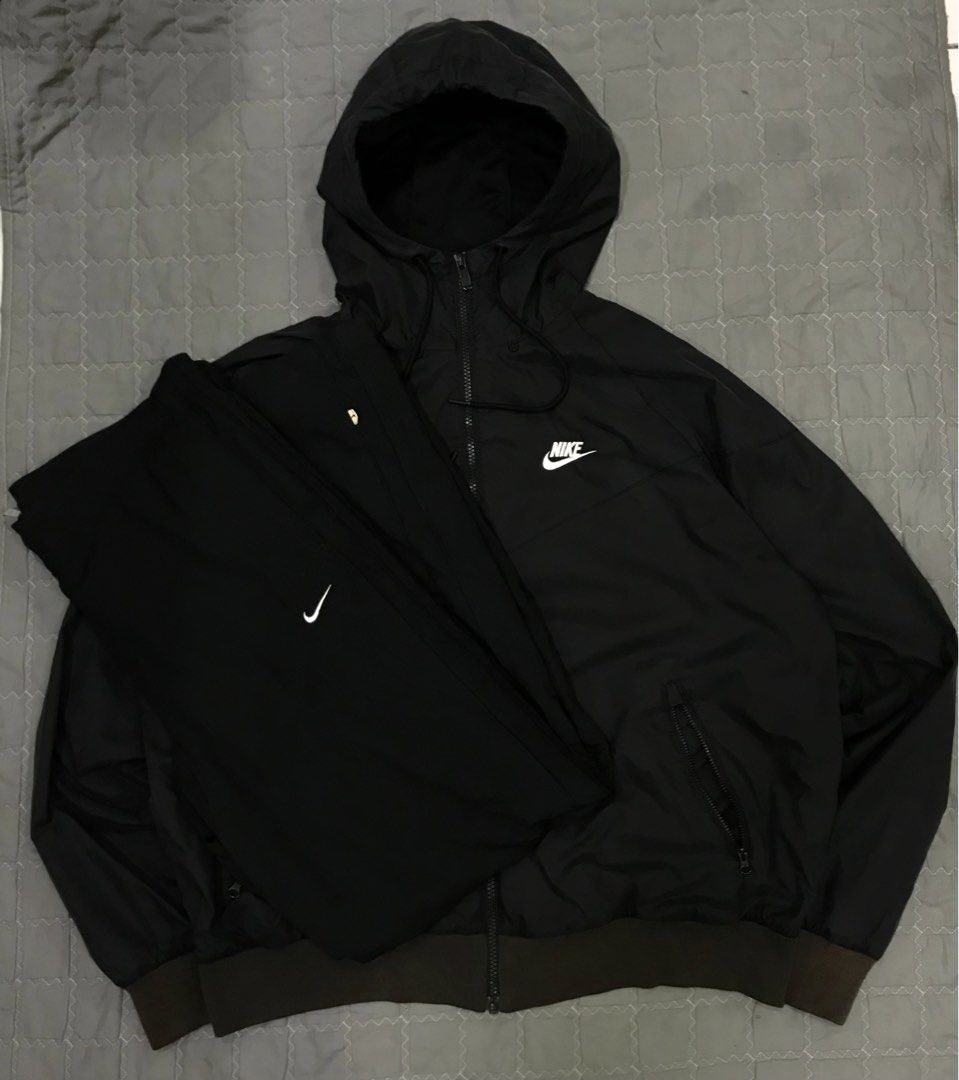 Nike Black Windbreaker Jacket and Pants Set (Category: Coats, Jackets and Outerwear) located in Imus. Submitted by yoboi.04 (Listing ID 1469054464, Image 1). Description: Nike black matching set. Full zip hooded windbreaker jacket with drawstring hood. Matching bottoms included. Both pieces feature white Nike branding. Size large, manufactured in Vietnam. Outer shell 100% nylon, inner mesh 100% polyester. Great tracksuit for workouts or casual da