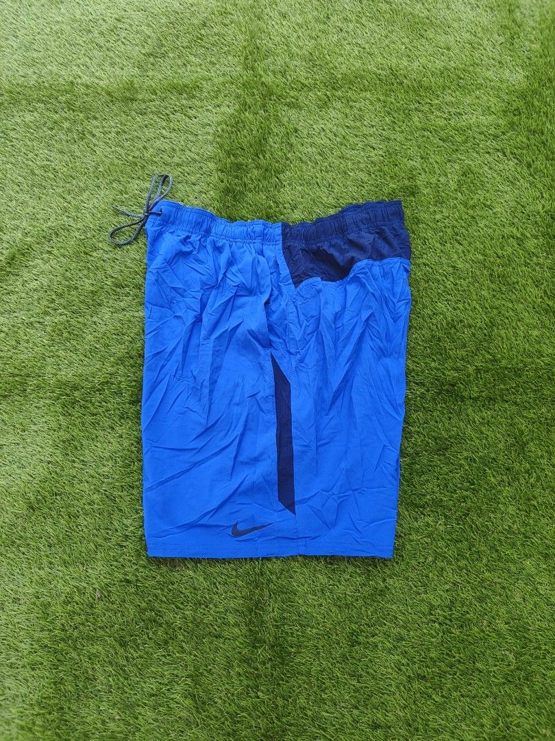 Nike Blue Athletic Shorts (Category: Shorts) located in Dipolog. Submitted by vinzz_thrift (Listing ID 1468971393, Image 1). Description: - Brand: Nike - Color: Blue with dark blue side panels - Size: XL - Features: Inner mesh lining, elastic waistband with adjustable speckled drawstring, and Nike logo near the hem - Origin: Made in Indonesia - Condition: Excellent.