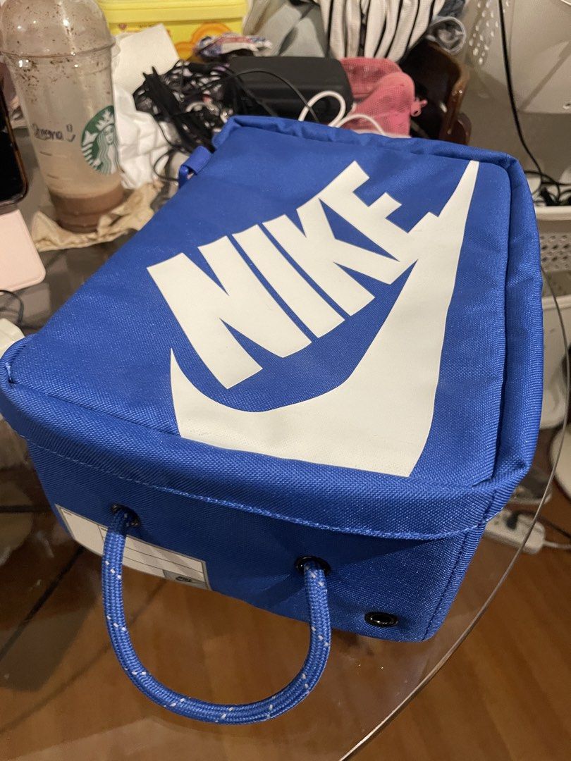Nike Blue Shoe Box Bag - Small 8L (Category: Belt bags, Clutches and Pouches) located in Pasig City. Submitted by sheenabelle_ (Listing ID 1469107045, Image 1). Description: - Authentic blue Nike shoe box bag with large white logo print - Sturdy rope handle and secure zip closure - Interior mesh zippered pocket for small essentials - Includes cardboard insert to maintain structure and shape - Detachable strap included inside - Ideal for stylish s