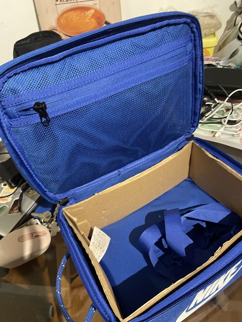Nike Blue Shoe Box Bag - Small 8L (Category: Belt bags, Clutches and Pouches) located in Pasig City. Submitted by sheenabelle_ (Listing ID 1469107045, Image 3). Description: - Authentic blue Nike shoe box bag with large white logo print - Sturdy rope handle and secure zip closure - Interior mesh zippered pocket for small essentials - Includes cardboard insert to maintain structure and shape - Detachable strap included inside - Ideal for stylish s