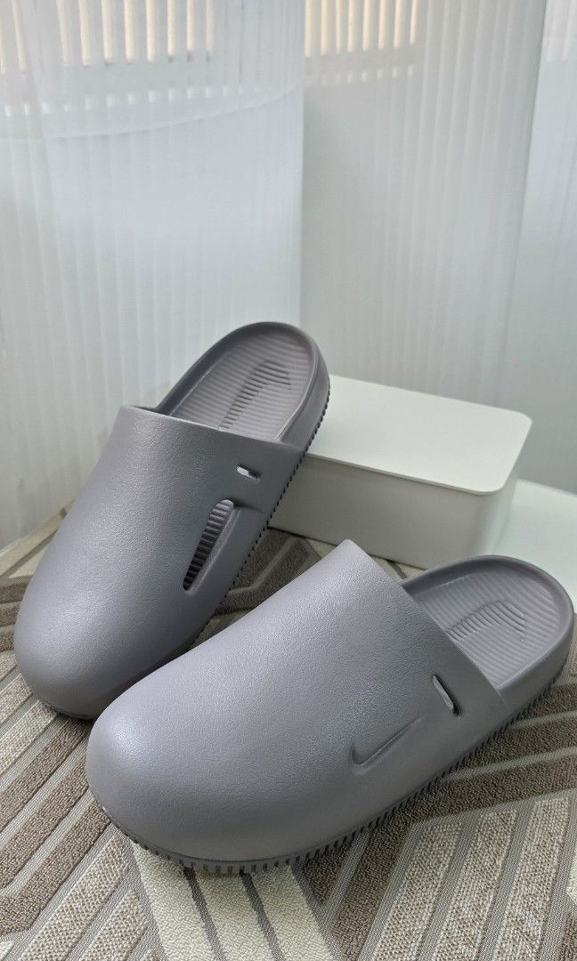 Nike Calm Mules (Category: Slippers & Slides) located in Malabon City. Submitted by j.a.rubio (Listing ID 1469051479, Image 1). Description: Nike Calm Mules with Strap Flat Pewter size 9M/10W original price Php3,695 like new, used twice only (indoor) with box & strap rfs. not using it anymore Php 999.
