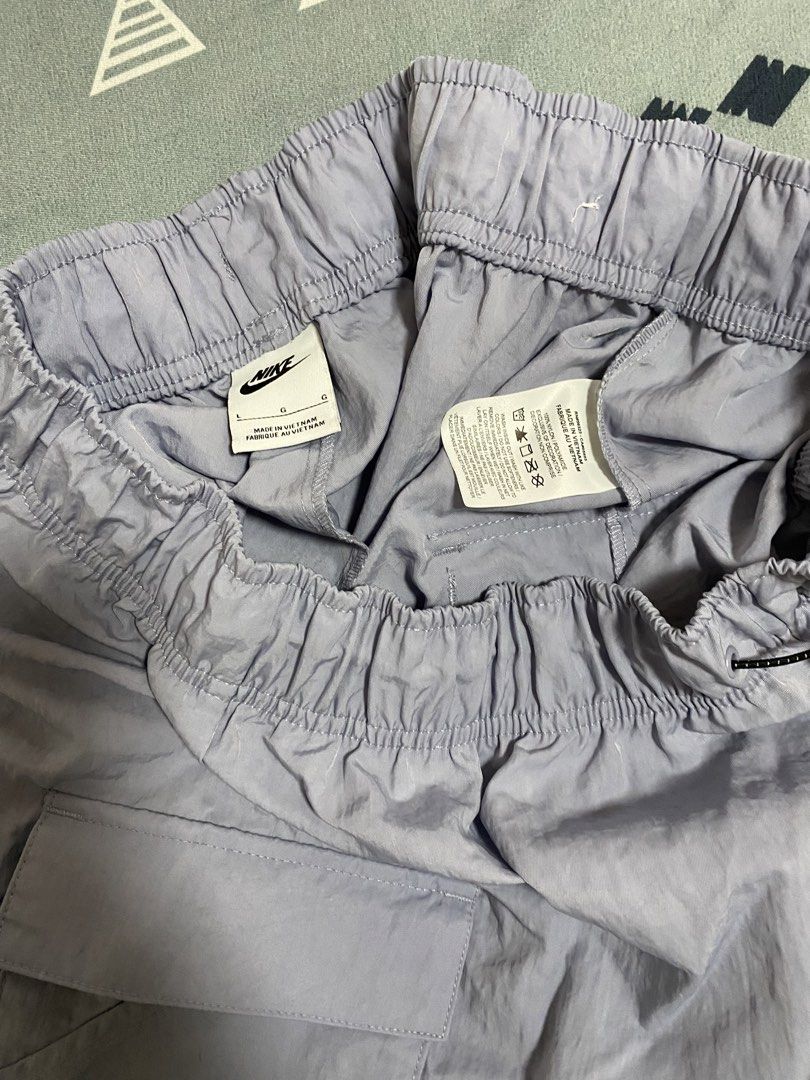 Nike Cargo Shorts Light Purple Size L (Category: Shorts) located in Taguig. Submitted by maaarrrrrcky (Listing ID 1469017436, Image 3). Description: - Brand: Nike - Item: Cargo Shorts - Color: Light Purple - Size: Large (L) - Material: 100% Nylon (Made in Vietnam) - Waistband: Elastic with adjustable bungee toggle drawstring - Pockets: Dual side cargo pockets + 1 back pocket with Nike Swoosh logo.