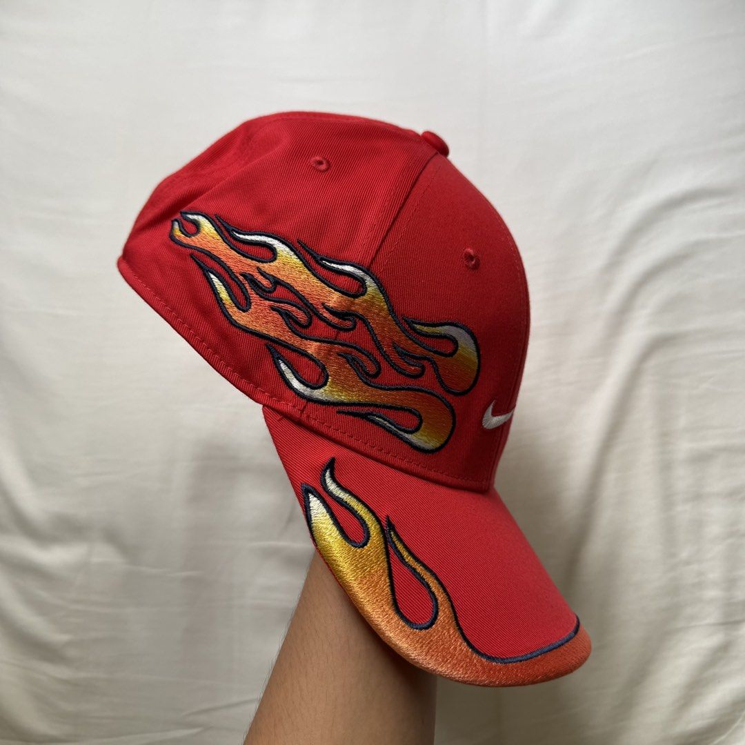Nike Club Structured OG Flame Cap (Category: Caps & Hats) located in Pasig City. Submitted by notshynotmeee (Listing ID 1468960780, Image 3). Description: - Brand: Nike - Color: Bold red with yellow, orange, and white embroidered flames - Logos: White Nike swoosh on the front, mini swoosh on the adjustable strapback - Design: Structured fit with flames wrapping around the sides and brim - Condition: Clean structure with vivid colors Clean, never 