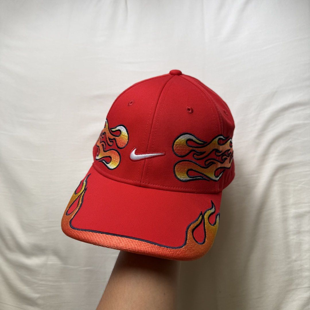 Nike Club Structured OG Flame Cap (Category: Caps & Hats) located in Pasig City. Submitted by notshynotmeee (Listing ID 1468960780, Image 1). Description: - Brand: Nike - Color: Bold red with yellow, orange, and white embroidered flames - Logos: White Nike swoosh on the front, mini swoosh on the adjustable strapback - Design: Structured fit with flames wrapping around the sides and brim - Condition: Clean structure with vivid colors Clean, never 