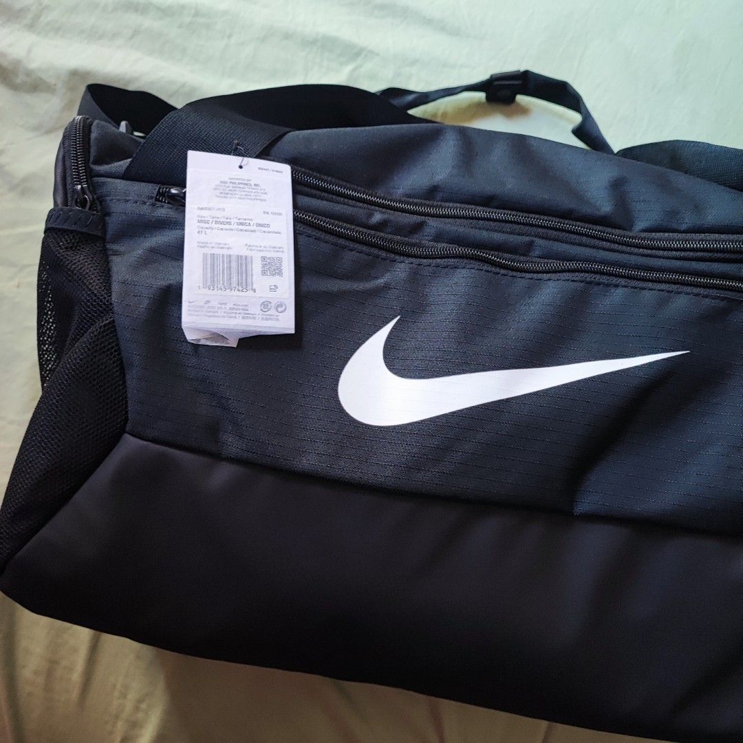 Nike Duffel Bag Black 41L (Category: Backpacks) located in Taytay. Submitted by ampolalay (Listing ID 1469069805, Image 2). Description: - Brand: Nike - Color: Black with large white swoosh - Capacity: 41 liters - Condition: Brand new with original retail tags attached - Material: Durable fabric construction - Storage: Multiple zipped compartments and convenient mesh side pocket - Details: Custom branded zipper pulls.