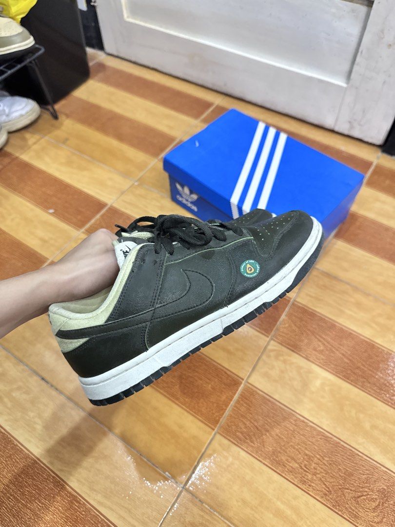 Nike Dunk Low Avocado Size 7.5 (Category: Sneakers) located in Tarlac. Submitted by kyasonik (Listing ID 1468963358, Image 3). Description: - Model: Nike Dunk Low Avocado - Size: US 7.5 / UK 5 / EUR 38.5 - Color/Design: Olive green leather upper with an adorable avocado sticker near the toe box and a unique fuzzy heel tab - Condition: Shows light wear on the soles and inner lining, but overall still has plenty of life left - no box included.
