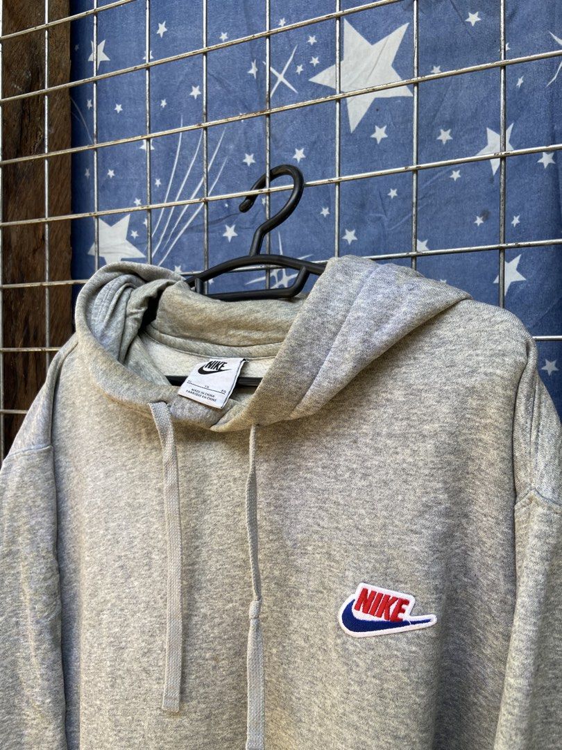 Nike Gray Hoodie with Big Back Logo (Category: Hoodies) located in Cagayan de Oro. Submitted by mindanao_thrifters (Listing ID 1468944279, Image 2). Description: - Authentic gray Nike hoodie with comfortable fleece lining inside - Features a small retro embroidered Nike patch on the left chest - Eye-catching large orange Nike Sportswear text and swoosh printed on the back - Drawstring hood, front kangaroo pocket, and ribbed cuffs and hem - Standa