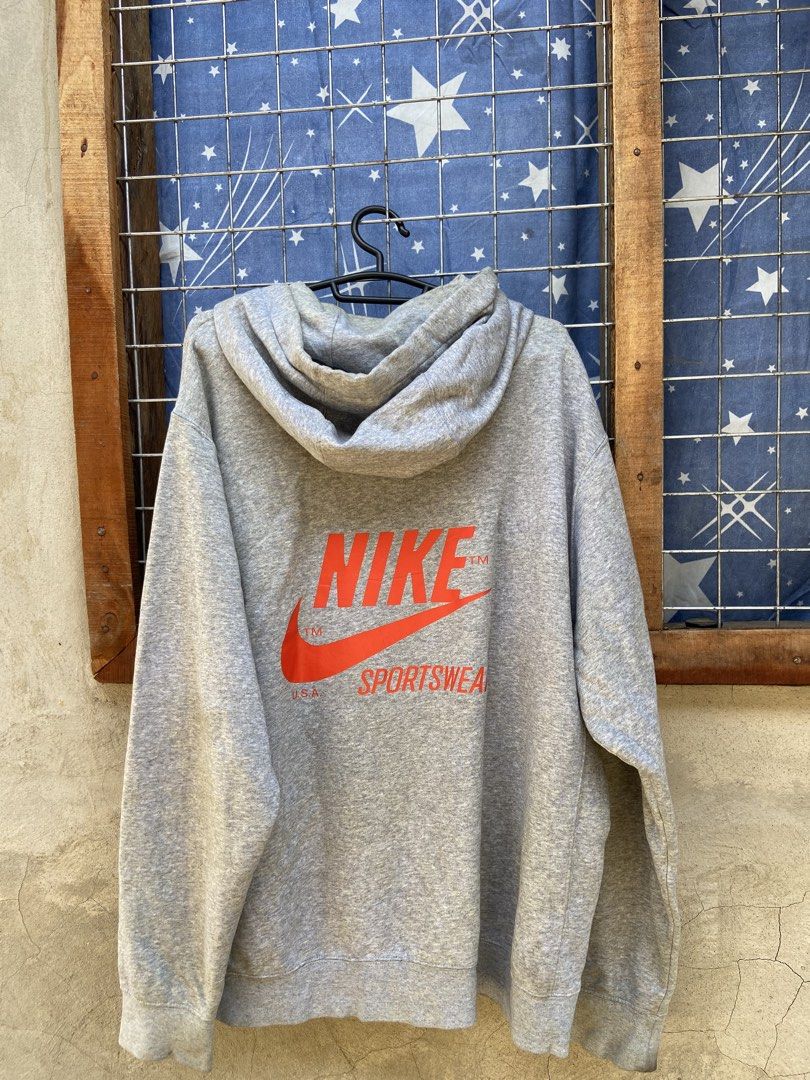 Nike Gray Hoodie with Big Back Logo (Category: Hoodies) located in Cagayan de Oro. Submitted by mindanao_thrifters (Listing ID 1468944279, Image 3). Description: - Authentic gray Nike hoodie with comfortable fleece lining inside - Features a small retro embroidered Nike patch on the left chest - Eye-catching large orange Nike Sportswear text and swoosh printed on the back - Drawstring hood, front kangaroo pocket, and ribbed cuffs and hem - Standa