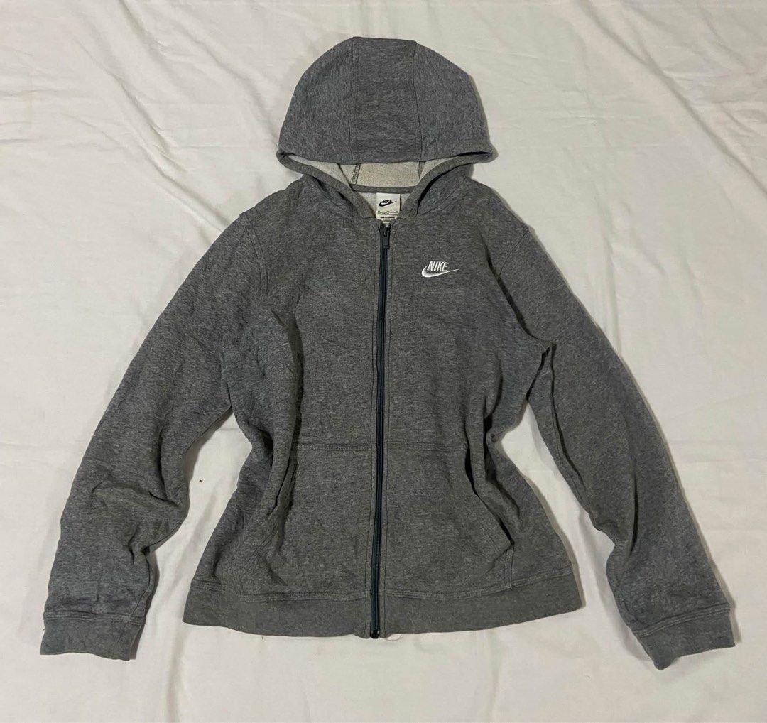 Nike Grey Zip-Up Hoodie (Category: Hoodies) located in Baybay. Submitted by comicowl (Listing ID 1469102010, Image 1). Description: - Brand: Nike - Color: Grey with white embroidered logo - Style: Zip-up hoodie with split kangaroo pockets - Material: Comfortable cotton blend - Fit/Details: Ribbed cuffs and hem, attached hood (drawstrings missing) - Condition: Great everyday casual staple.