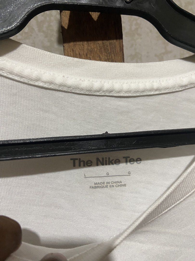Nike Just Do It White T-Shirt Size L (Category: Shirts) located in Cagayan de Oro. Submitted by mindanao_thrifters (Listing ID 1468944678, Image 3). Description: - Brand: Nike - Color: White with large black 'Just Do It' graphic - Size: Large (Standard Fit) - Material: 100% Cotton - Style: Classic crew neck, short sleeve - Origin: Made in China - Condition: Excellent, easy to style with shorts or jeans.