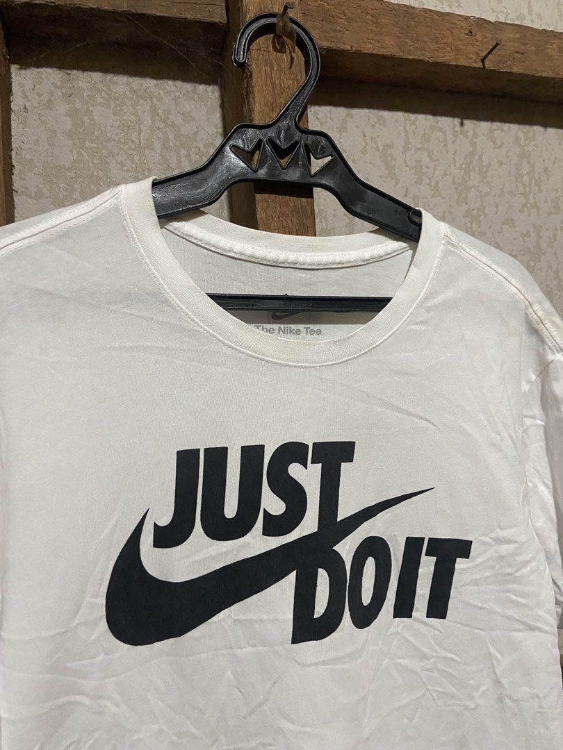 Nike Just Do It White T-Shirt Size L (Category: Shirts) located in Cagayan de Oro. Submitted by mindanao_thrifters (Listing ID 1468944678, Image 2). Description: - Brand: Nike - Color: White with large black 'Just Do It' graphic - Size: Large (Standard Fit) - Material: 100% Cotton - Style: Classic crew neck, short sleeve - Origin: Made in China - Condition: Excellent, easy to style with shorts or jeans.