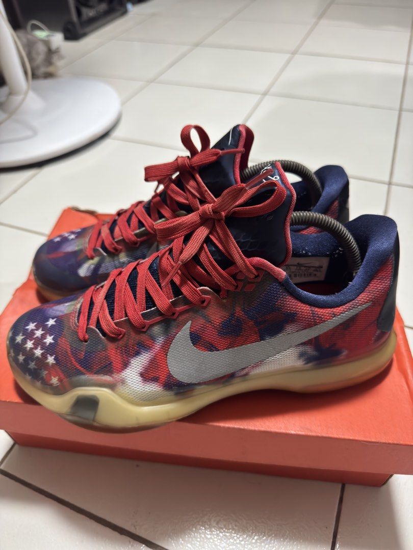 Nike Kobe 10 Independence Day (Category: Sneakers) located in Manila. Submitted by mislangers_stuff (Listing ID 1469052661, Image 3). Description: - Brand/Model: Nike Kobe X USA - Size: US 8.5 / EUR 42 - Design: Patriotic flag graphic with stars and red accents - Sole: Translucent yellow rubber with iconic gold X logo - Condition: Light wear on outsole tread - Inclusion: Comes with original orange box - Ideal for: Basketball players and sneaker c