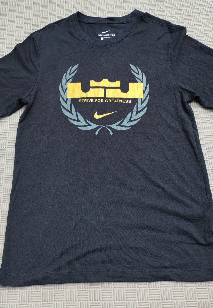Nike LeBron Strive For Greatness Dri-Fit Tee (Category: Activewear) located in Santa Rosa. Submitted by big.hanger.apparel (Listing ID 1469076531, Image 2). Description: NIKE — THE NIKE TEE • Brand: Nike • Gender: Male • Size: Medium • Fit: Dri-FIT Athletic Fit • Condition: Very Good— 8/10 • Description: Black Nike Dri-FIT T-shirt featuring a bold “LeBron James” inspired crown graphic with laurel wreath detailing and “STRIVE FOR GREATNESS” text o