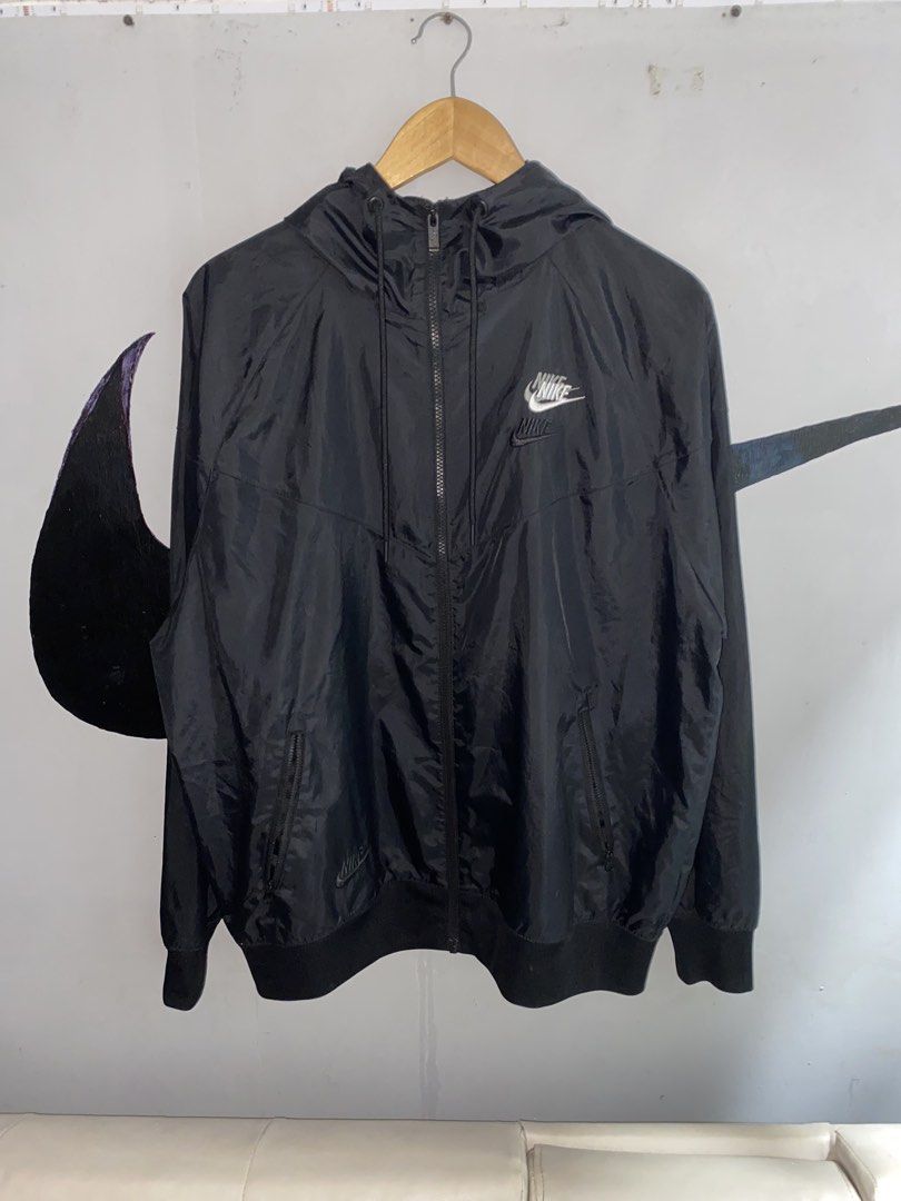 Nike Multiple Logo Windbreaker Black Large (Category: Coats, Jackets and Outerwear) located in Manila. Submitted by japhetcond32104 (Listing ID 1469111349, Image 1). Description: - Brand: Nike - Item: Windbreaker Jacket - Color: Black - Size: Large (on tag) - Design: Multiple stacked logos on the chest and lower hem - Features: Full zip front, adjustable hood with drawstrings, ribbed cuffs and hem, and secure zippered side pockets - Condition: Ex