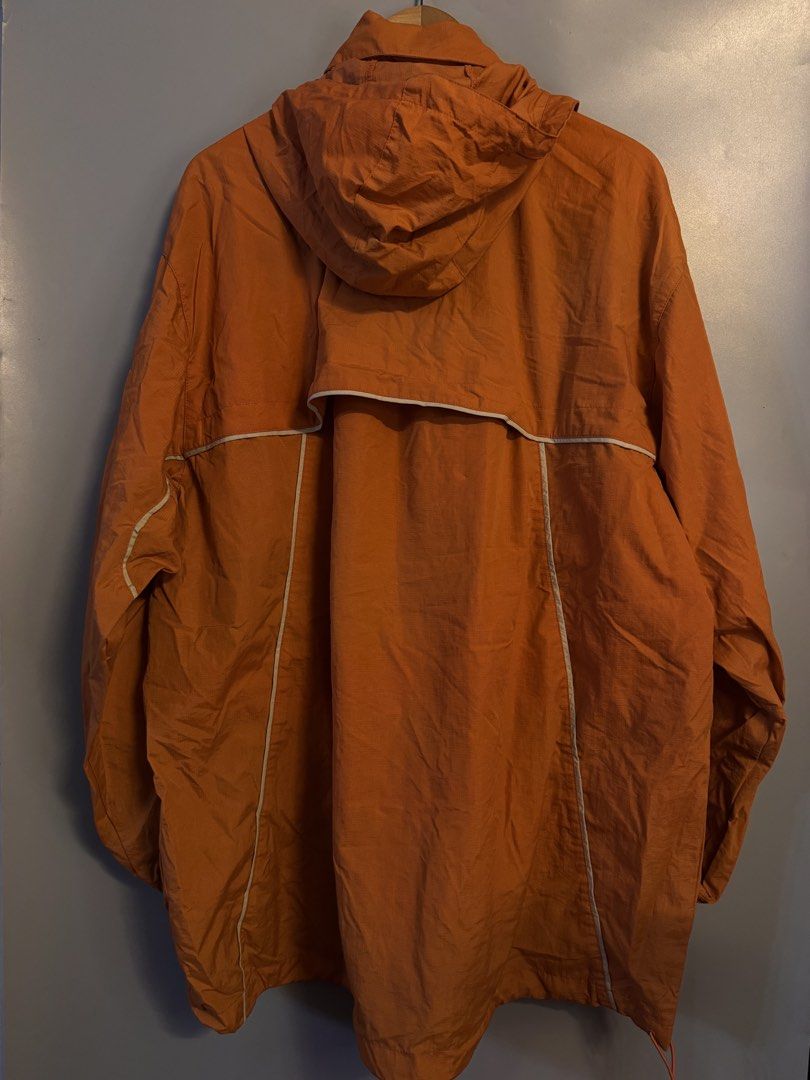 Nike Orange Half-Zip Hooded Windbreaker Jacket (Category: Coats, Jackets and Outerwear) located in Alaminos. Submitted by outfitcheck.ph (Listing ID 1469102125, Image 2). Description: - Brand: Nike - Size: 2XL - Color: Bright orange with white piping details - Features: Half-zip, hood, mesh lining, and adjustable drawstring hem - Pockets: Front flap pocket with dark button closure - Branding: Embroidered Nike swoosh on the left sleeve - Origin: M