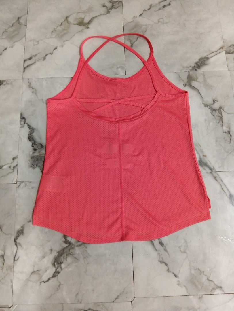 Nike Pink Workout Tank Top (Category: Activewear) located in Pasig City. Submitted by rachelleduarte_12272406 (Listing ID 1468977443, Image 2). Description: - Brand: Nike - Color: Bright pink - Material: Lightweight, breathable mesh - Design: Racerback with double criss-cross straps - Hem: Curved with a longer back - Logo: White Nike swoosh near the front hem - Ideal for: Workouts, running, and active lifestyle.