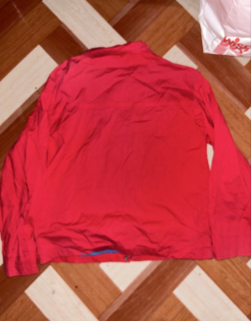 Nike Red Vintage Jacket Full Zip Windbreaker (Category: Coats, Jackets and Outerwear) located in Manila. Submitted by yoshi_shin (Listing ID 1469149637, Image 2). Description: - Color: Vibrant red with contrasting light blue inner lining - Closure: Full front zipper with button fasteners at hem and cuffs - Pockets: Two secure zippered side pockets - Branding: Small white embroidered Nike logo on upper left chest - Back: Clean solid red back panel