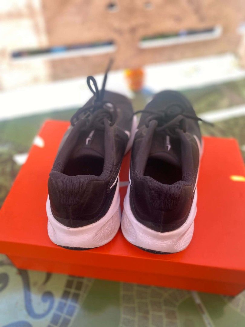 Nike revolution 7 size 10 used (Category: Sneakers) located in Bulacan. Submitted by cedriconeza16 (Listing ID 1468937567, Image 3). Description: - Brand: Nike Revolution 7 - Colorway: Black and White - Size: Men US 10 - Condition: Pre-owned with minor dirt marks on the outsole - Features: Breathable mesh upper, iconic side swoosh, comfortable white foam midsole, and textured rubber outsole - Inclusion: Original orange shoebox with size label inc