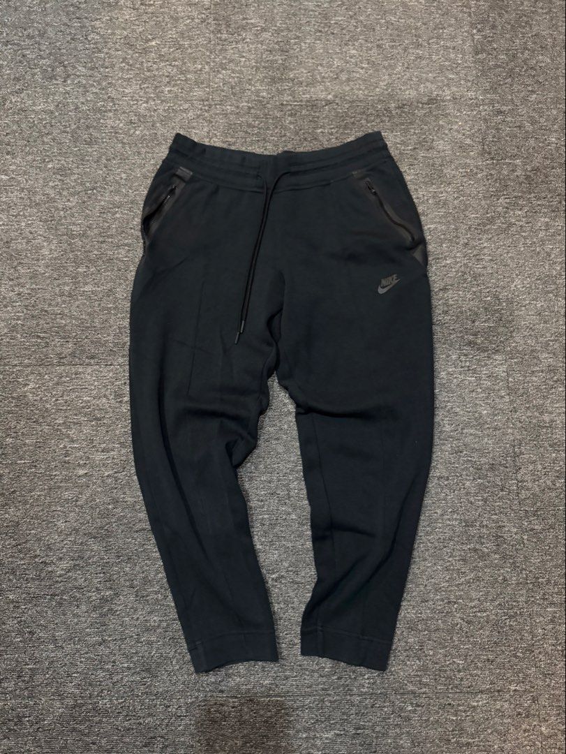 Nike Tech Fleece Black Sweatpants Size XL (Category: Joggers) located in Mabalacat. Submitted by _allinmarket (Listing ID 1469104928, Image 1). Description: Black Nike sweatpants in size XL. Features zip pockets on both sides and an adjustable drawstring waistband. Ribbed cuffs at the bottom. Classic swoosh logo printed near the left pocket. Made in China. Comfortable material, great everyday wear..