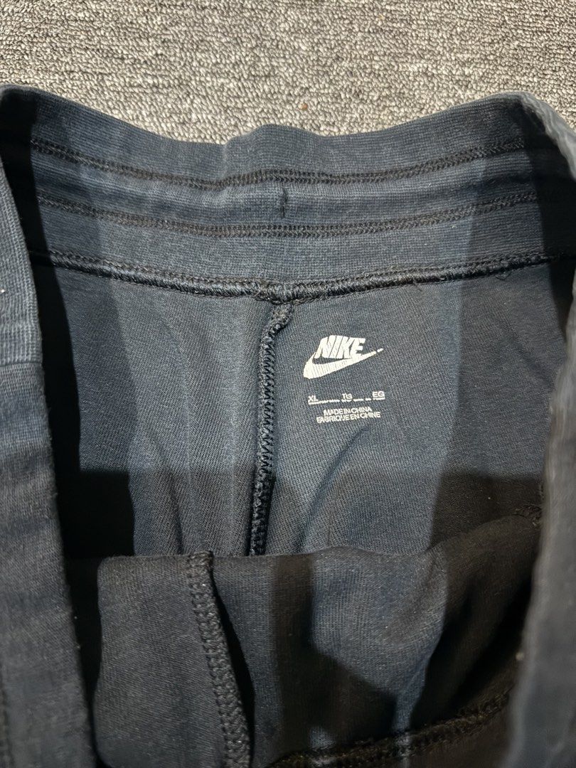 Nike Tech Fleece Black Sweatpants Size XL (Category: Joggers) located in Mabalacat. Submitted by _allinmarket (Listing ID 1469104928, Image 3). Description: Black Nike sweatpants in size XL. Features zip pockets on both sides and an adjustable drawstring waistband. Ribbed cuffs at the bottom. Classic swoosh logo printed near the left pocket. Made in China. Comfortable material, great everyday wear..