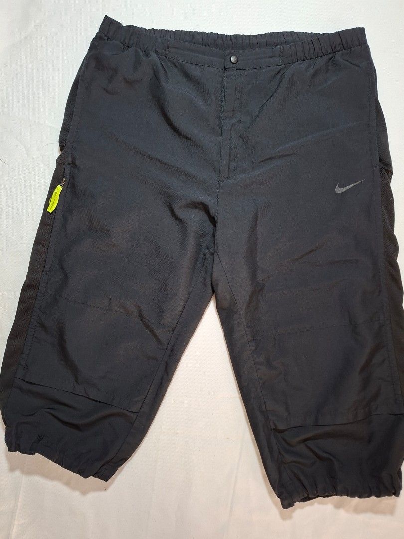 Nike Tech Training Black Athletic Shorts Pants (Category: Shorts) located in Baguio. Submitted by restyrille77846 (Listing ID 1469053184, Image 1). Description: - Brand: Nike - Color: Black training pants - Features: Elastic waistband, gathered cuffs, and neon green Tech Training zipper pull with Nike swoosh logo - Perfect for workouts, lounging, or casual streetwear - DM for more details or fast shipping!.