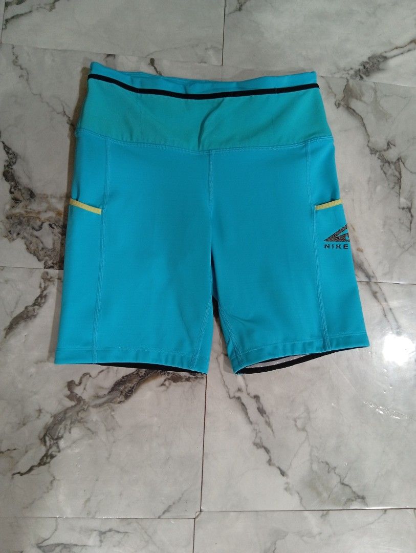 Nike Trail Blue Running Shorts with Pockets (Category: Activewear) located in Pasig City. Submitted by rachelleduarte_12272406 (Listing ID 1468943840, Image 1). Description: - Brand: Nike Trail - Color: Bright blue with contrasting yellow accents - Fit: High waist design - Pockets: Convenient drop-in side pockets and secure back zippered pocket - Material: Durable athletic fabric - Ideal For: Outdoor running and hiking.