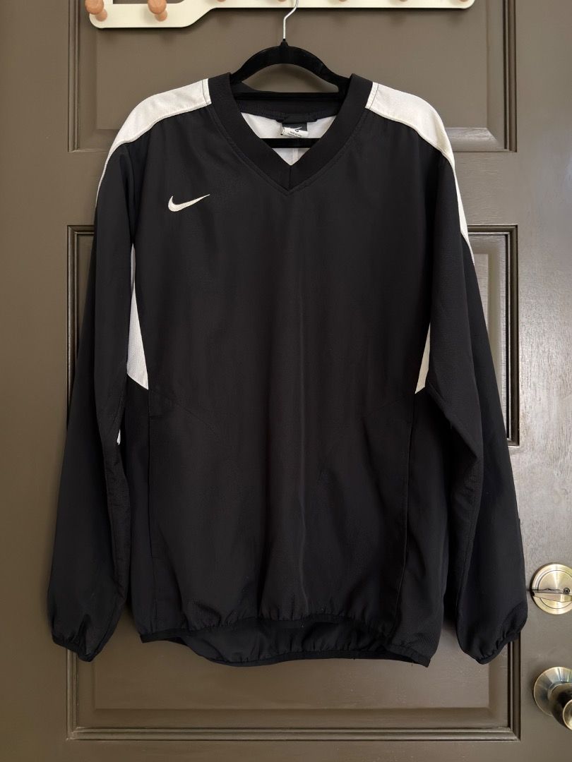 Nike V-Neck Windbreaker Jacket Black White (Category: Coats, Jackets and Outerwear) located in Calamba. Submitted by prongsiepoo (Listing ID 1469081071, Image 1). Description: - Brand: Nike - Style: Long sleeve V-neck windbreaker pullover - Color: Classic black with contrasting white shoulder and sleeve panels - Details: Embroidered white Swoosh on right chest, elastic cuffs and hem - Material: Lightweight athletic fabric - Best for: Workouts, la